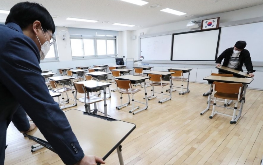 교직원들이 지난 1일 세종시의 한 고등학교에서 등교 개학을 대비해 코로나19 확산 방지 책걸상 배치 등을 점검하고 있다. / 연합뉴스