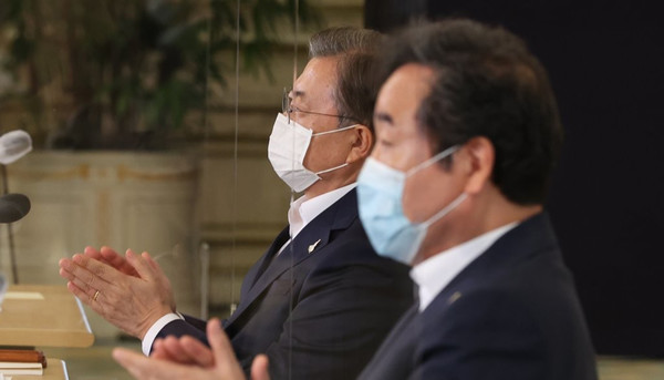 문재인 대통령과 더불어민주당 이낙연 대표가 3일 오전 청와대에서 열린 제1차 한국판 뉴딜 전략회의에서 나란히 앉아 홍남기 부총리 겸 기획재정부 장관의 뉴딜펀드 조성방안에 대한 발표를 들은 뒤 박수를 치고 있다./연합뉴스