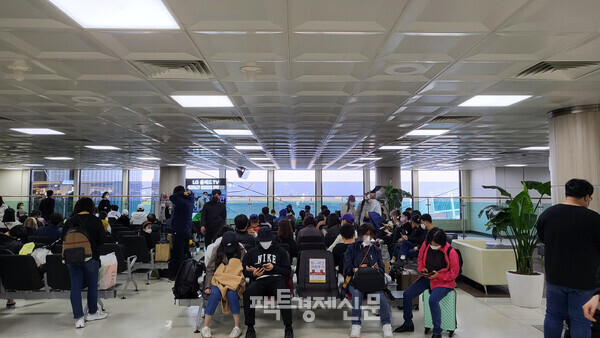 팩트경제신문이 14일 찾은 김포공항 탑승 대기석 모습. '좌석간 거리두기' 안내문구가 있지만, 관광객들은 서로 엉켜있다./김현우 기자