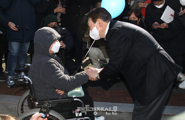 지난 13일, 여의도 국회의사당에서 진행된 '장문현답' 출정식에서 윤석열 국민의힘 대선후보가 장애인과 악수하고 있는 모습./옥지훈 기자