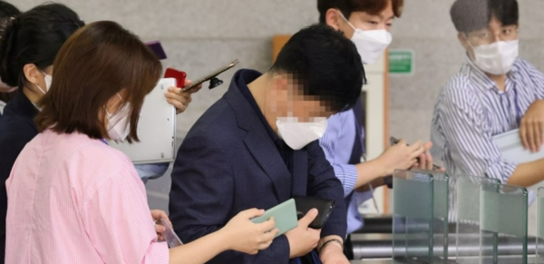 김문기 성남도시개발공사 개발1처장이 지난 10월,  대장동 개발 로비·특혜 의혹 사건 수사를 하는 서울중앙지검에 조사받기 위해 도착한 뒤 취재진 질문을 받으며 이동하고 있다./연합뉴스