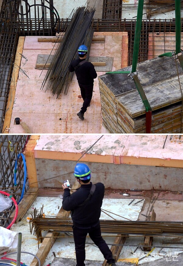 크레인이 적재물을 옮기는 중에 담배를 물고 있는 소형 타워크레인 조종사. /여성경제신문DB