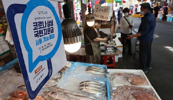 지난해 서울 노원구 상계중앙시장 전경. 생선을 파는 점포에 코로나 상생 국민지원금 사용 가능 안내문이 붙어있다. /연합뉴스
