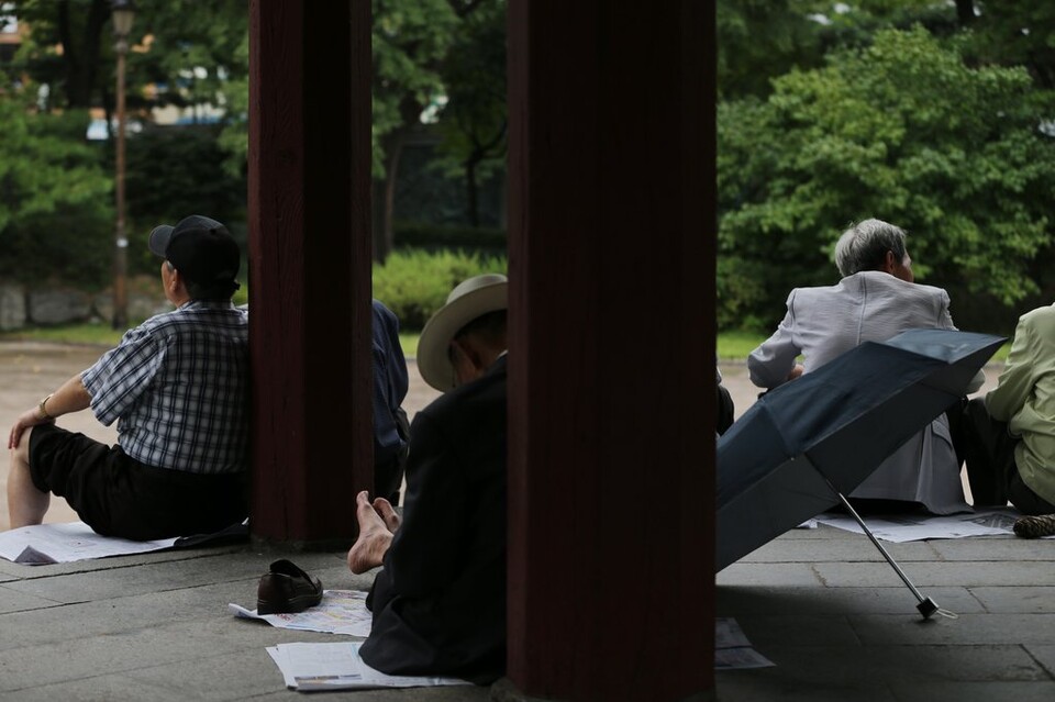 서울 종로구 탑골공원에서 노인들이 가을비를 바라보며 시간을 보내고 있다. /연합뉴스