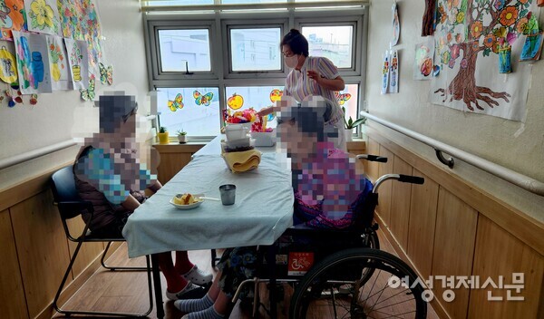 부산 사상구에서 만난 한 요양원의 요양보호사가 할머니들에게 간식을 제공하고 있다. 사진의 인물들은 기사 내용과 관련이 없음. /이상헌 기자