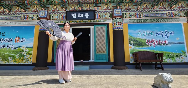 부채와 도깨비방망이를 들고 서 있는 김문주 자연치유센터 빛채움 대표. /김현우 기자