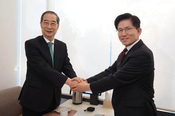 국민의힘 김문수 대선후보(오른쪽)와 무소속 한덕수 대선 예비후보가 전날 서울 종로구의 한 식당에서 후보 단일화 관련 회동을 하기 전 악수하고 있다. /연합뉴스