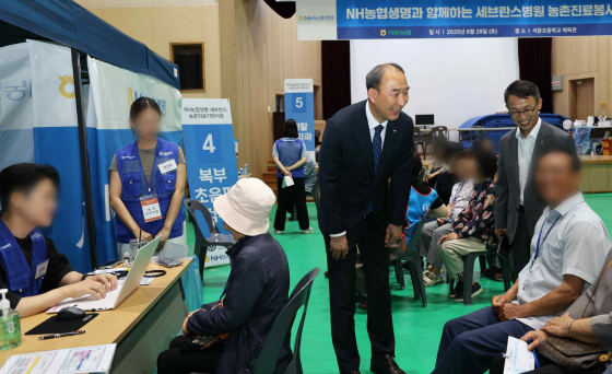 박병희 NH농협생명 대표이사가 의료 혜택을 받는 조합원을 살피고 있다. /NH농협생명